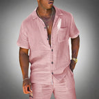 Man wearing a pink textured linen two-piece short-sleeve shirt and shorts set with a relaxed open collar