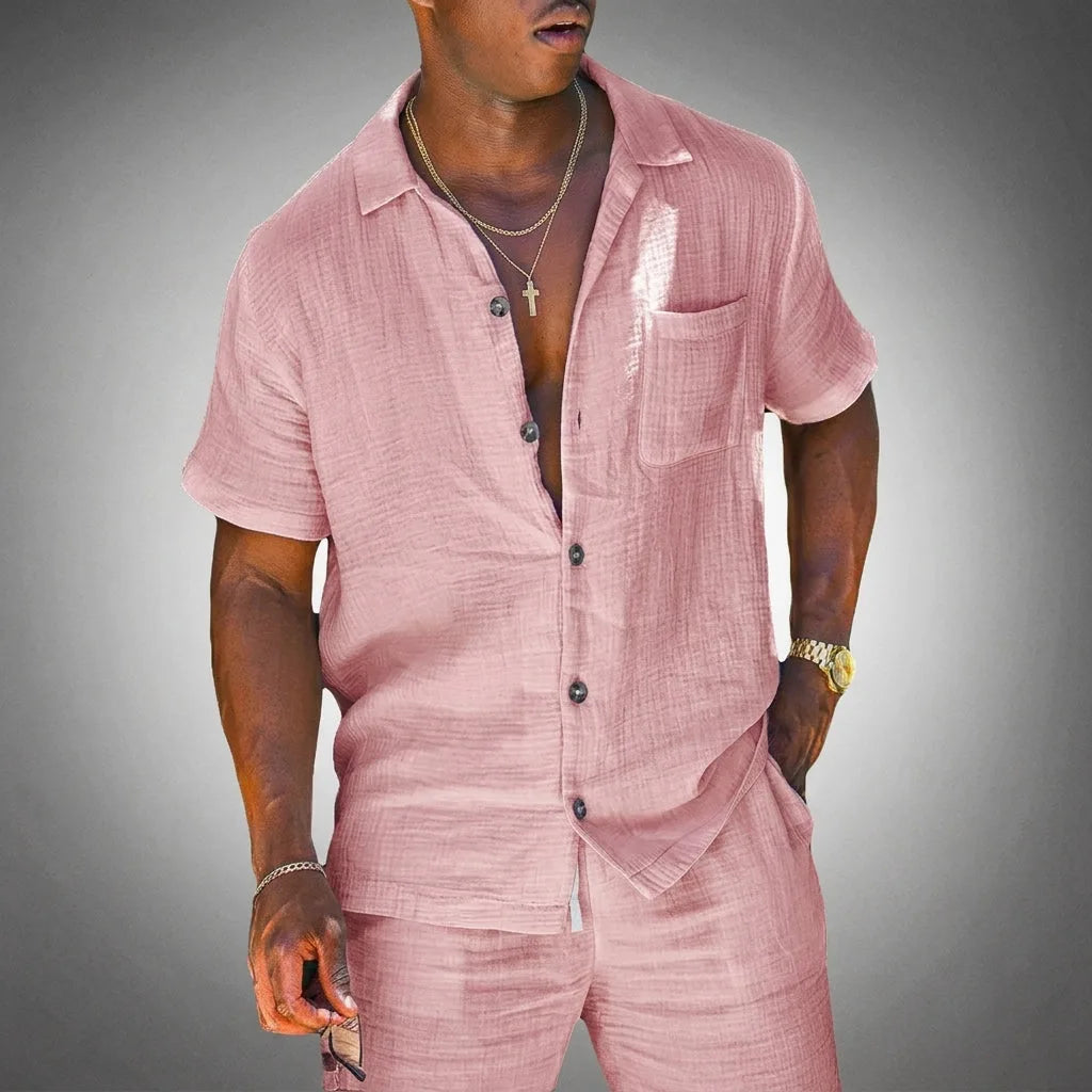 Man wearing a pink textured linen two-piece short-sleeve shirt and shorts set with a relaxed open collar
