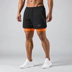 Front view of man wearing black 2-in-1 training shorts with orange compression liner and zip pocket