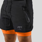 Close-up of black shorts fabric showing the zip pocket, drawstring and LYFT-style logo print
