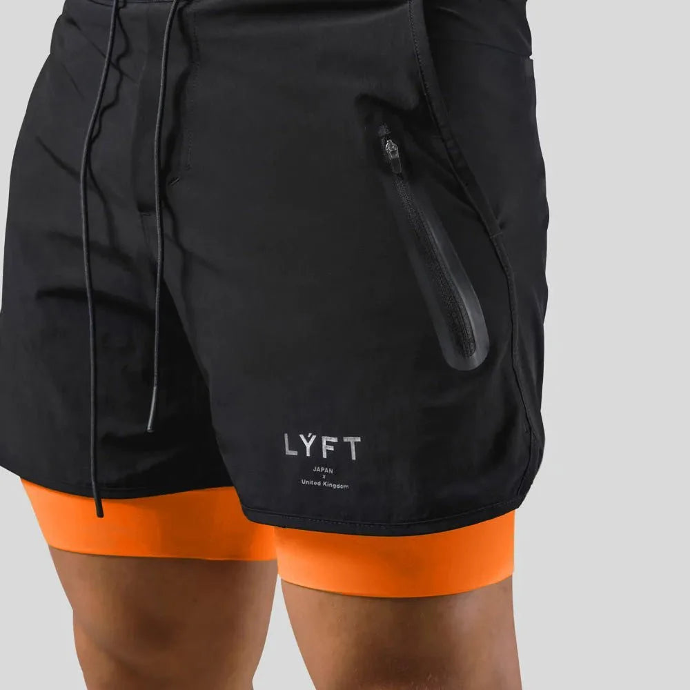 Close-up of black shorts fabric showing the zip pocket, drawstring and LYFT-style logo print