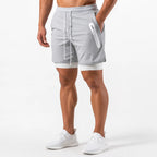 Front view of light grey 2-in-1 shorts with white drawstring and zip pocket worn with white sneakers