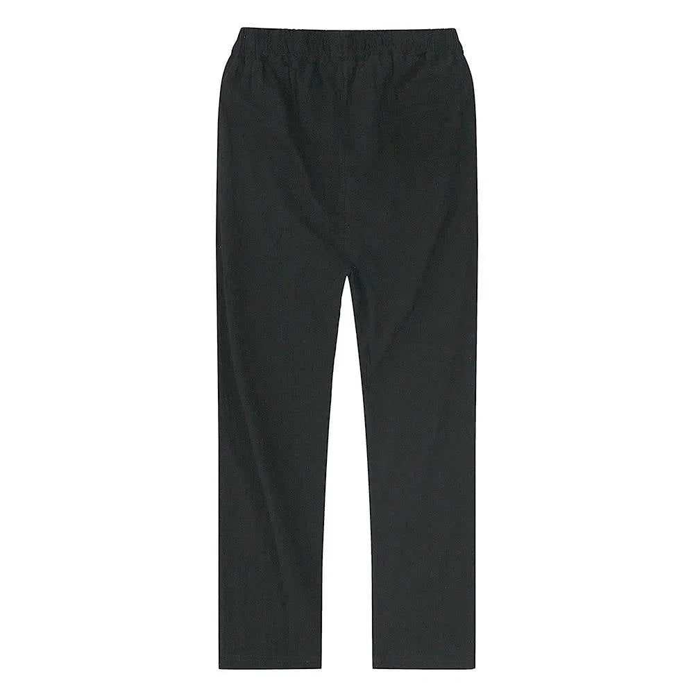 Front angled view of light blue linen pants showing drawstring tie detail at the waist