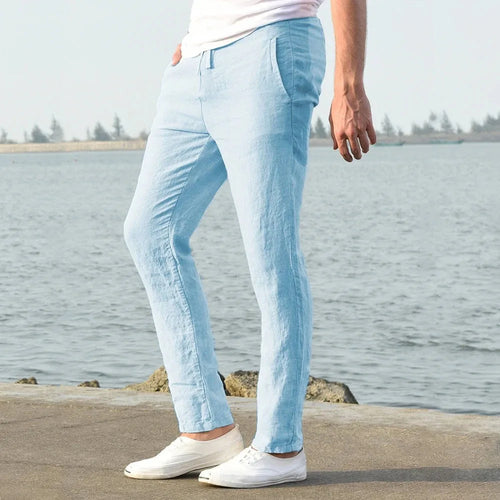 Side profile view of light blue linen pants showing straight leg cut and slim fit tapering to the ankle