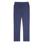 Man standing in black linen pants viewed from the side with hand tucked into the pocket