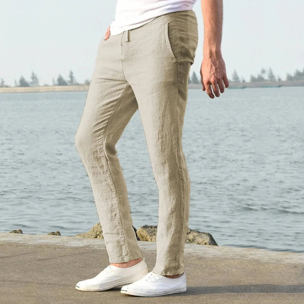 Side angle of light khaki linen pants highlighting the straight leg silhouette and front pocket seam