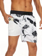 Side view of white tropical leaf print swim shorts with black trim, hand holding a phone in the hidden thigh pocket