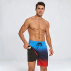 Man wearing ombre blue to red swim shorts with black drawstring, pulling the fabric aside to show the black liner and pocket