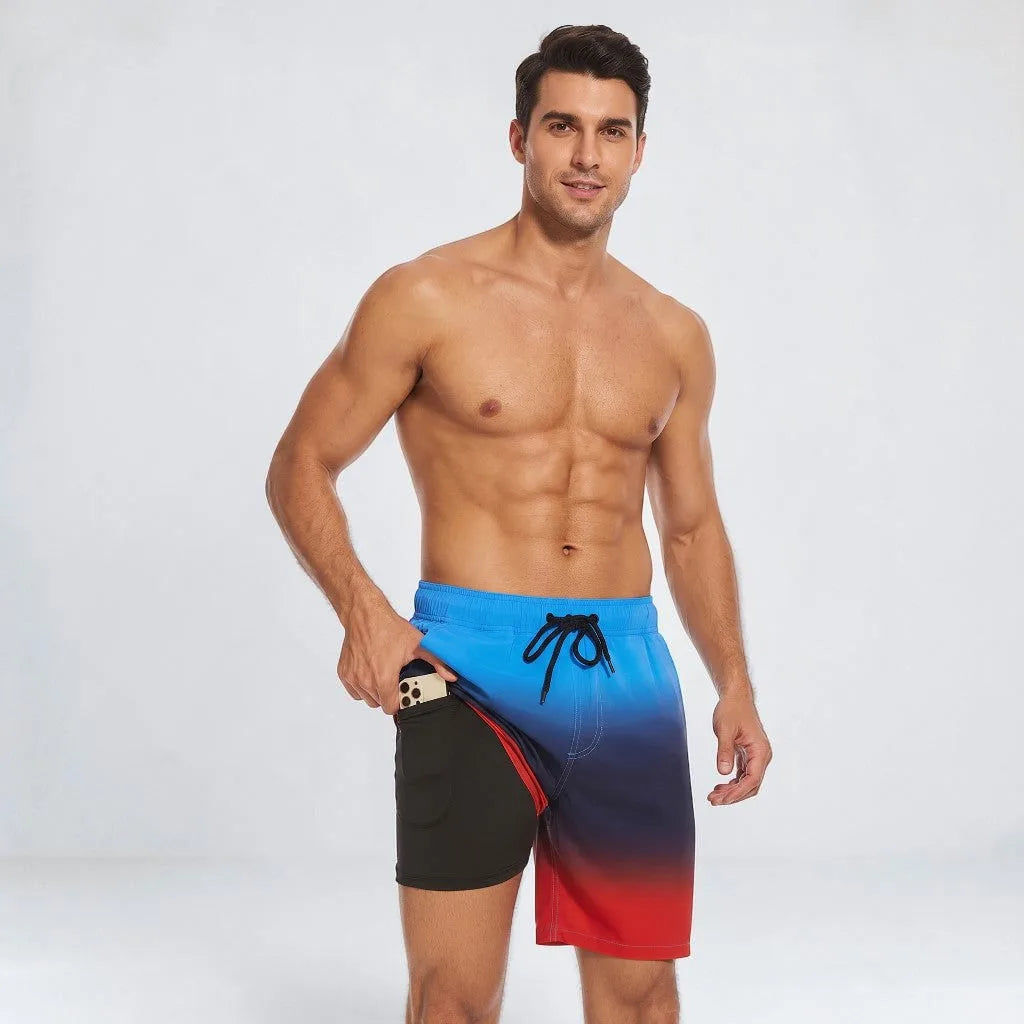 Man wearing ombre blue to red swim shorts with black drawstring, pulling the fabric aside to show the black liner and pocket