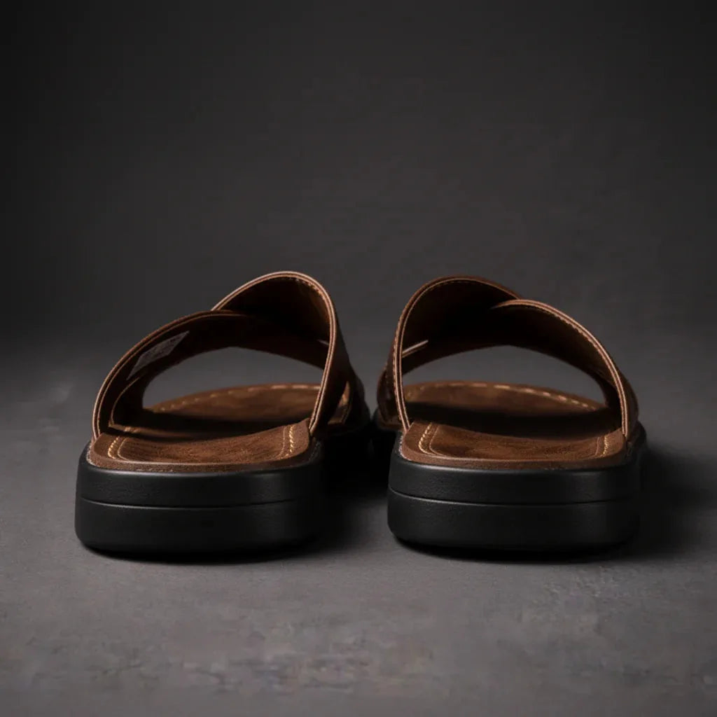 Back view of brown crossover sandals showing the stitched heel edge and stacked black sole