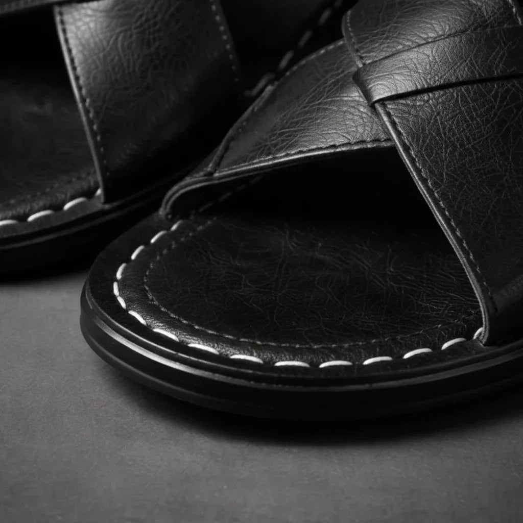 Close-up of the black crossover strap weave with white contrast stitching along the toe opening