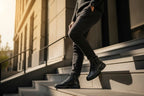 Man descending outdoor stairs wearing black grained leather boots with a chunky black sole