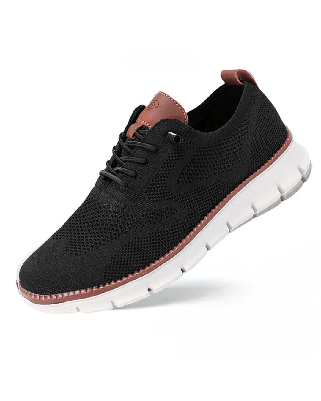 Black knit sneaker with tan leather trim at the heel and lace eyelets, white ridged outsole