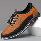 Angled side view of camel brown leather sneaker with black toggle laces and chunky rubber sole