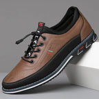 Three-quarter view of chestnut tan leather sneaker showing stitched toe cap and black heel panel