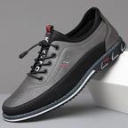 Side profile of charcoal grey leather sneaker with black suede trim and striped outsole