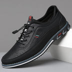 Close-up side view of midnight black leather sneaker with white outsole trim and tonal stitching