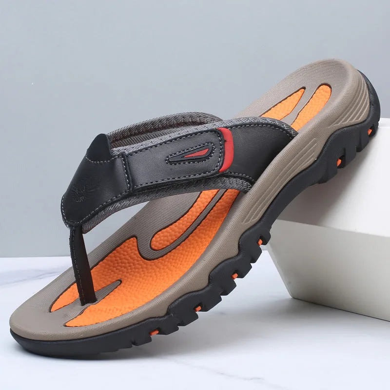 Camel tan leather thong sandal with orange footbed and black traction sole shown from above