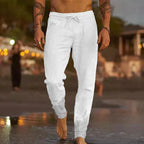 Front close-up of white linen-blend pants highlighting the woven texture and relaxed tapered fit