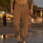 Front view of tan brown linen-blend pants with drawstring waist, tapered legs and relaxed fit