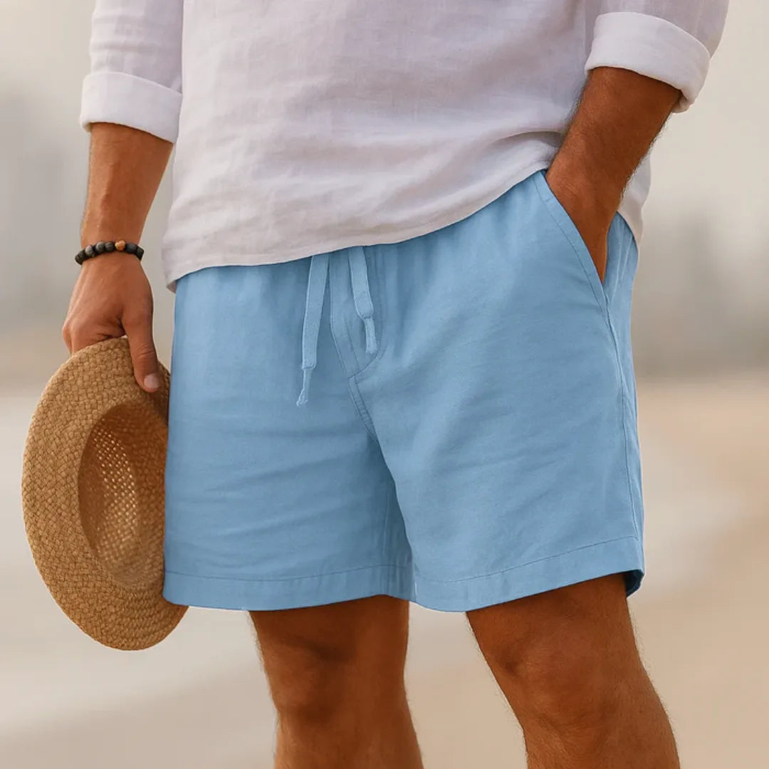 Sky blue linen-blend shorts with drawstring tie, paired with a white shirt and straw boater hat