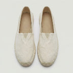 Close-up side angle of black canvas espadrille showing slip-on heel and woven upper