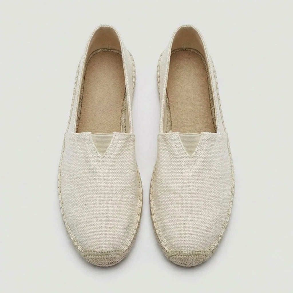 Close-up side angle of black canvas espadrille showing slip-on heel and woven upper