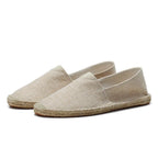 Side profile of white textured espadrille showing jute-wrapped sole and rounded toe
