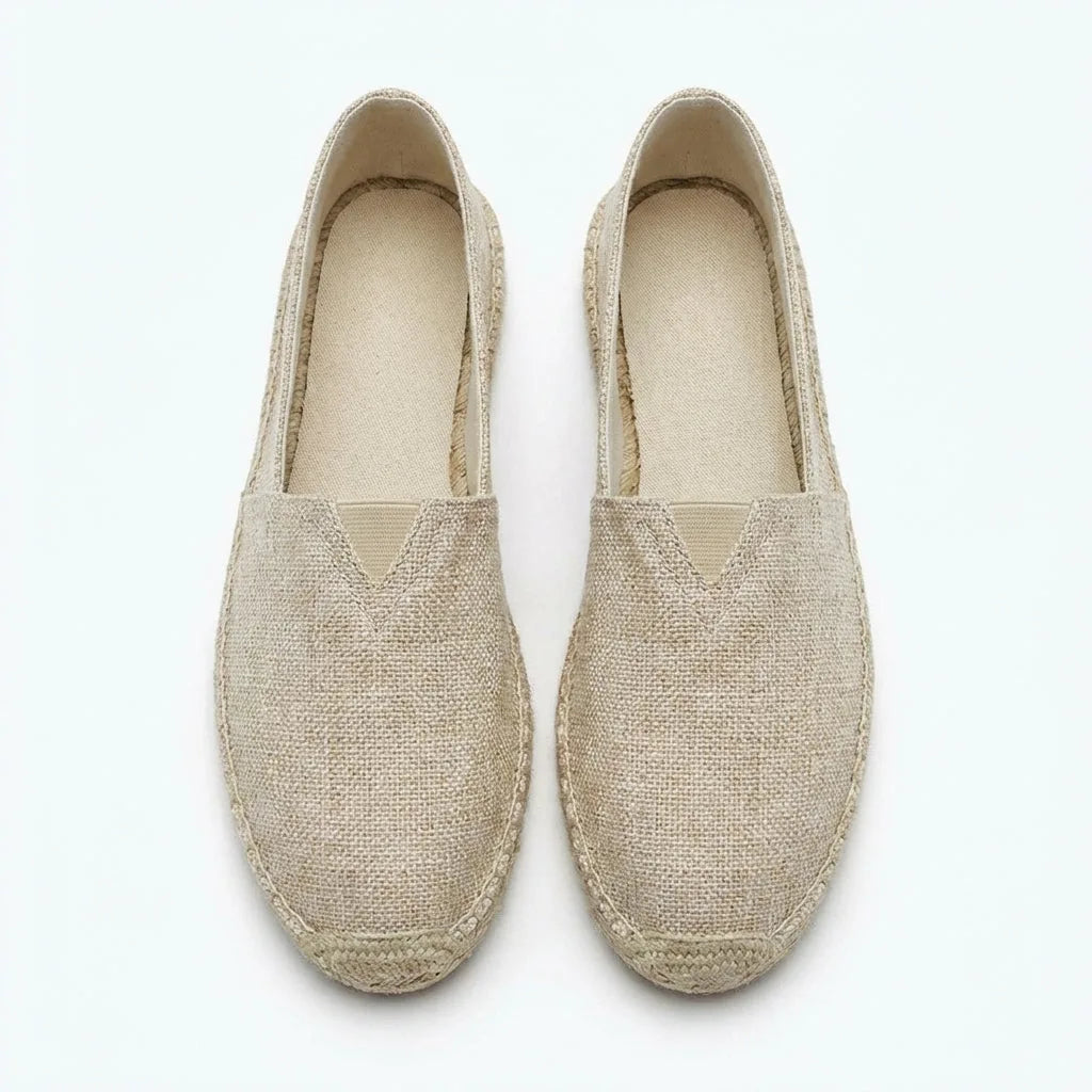 Top-down view of light beige espadrilles showing cream insole and woven upper texture