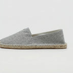 Close-up side profile of grey textured canvas espadrille with braided jute sole edge