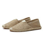 Top-down close-up of grey espadrilles highlighting the V-notch collar and woven texture