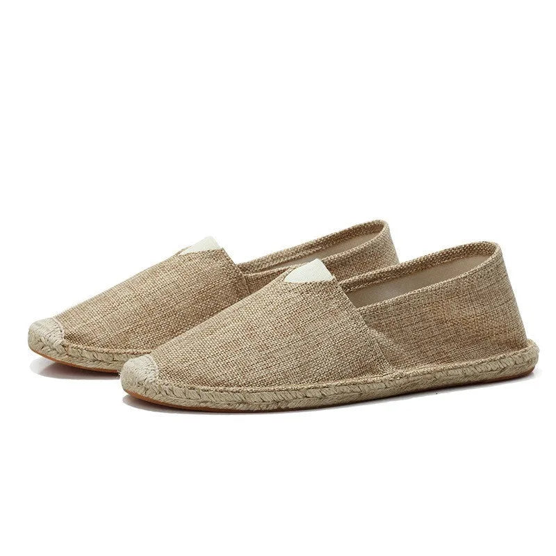 Top-down close-up of grey espadrilles highlighting the V-notch collar and woven texture