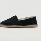 Top-down pair view of black espadrilles showing the V-notch front and jute sole trim