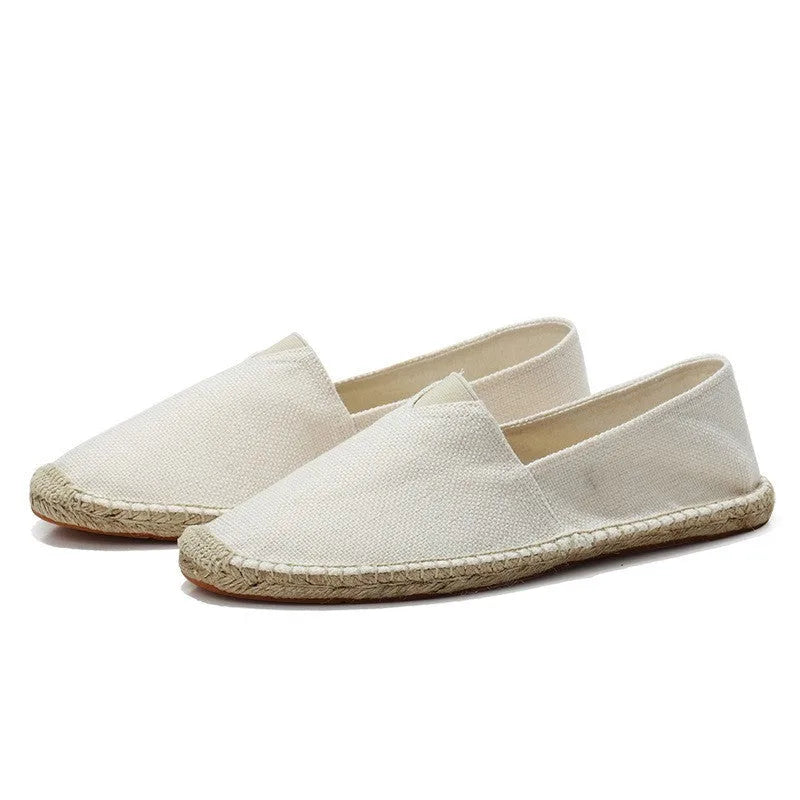 Side view of black woven espadrille highlighting the braided rope midsole detail