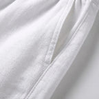 Close-up of the white linen side pocket opening with visible stitching and drawstring cord