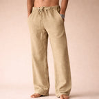Khaki linen trousers with drawstring waist and hand in side pocket, showing the natural woven linen texture.