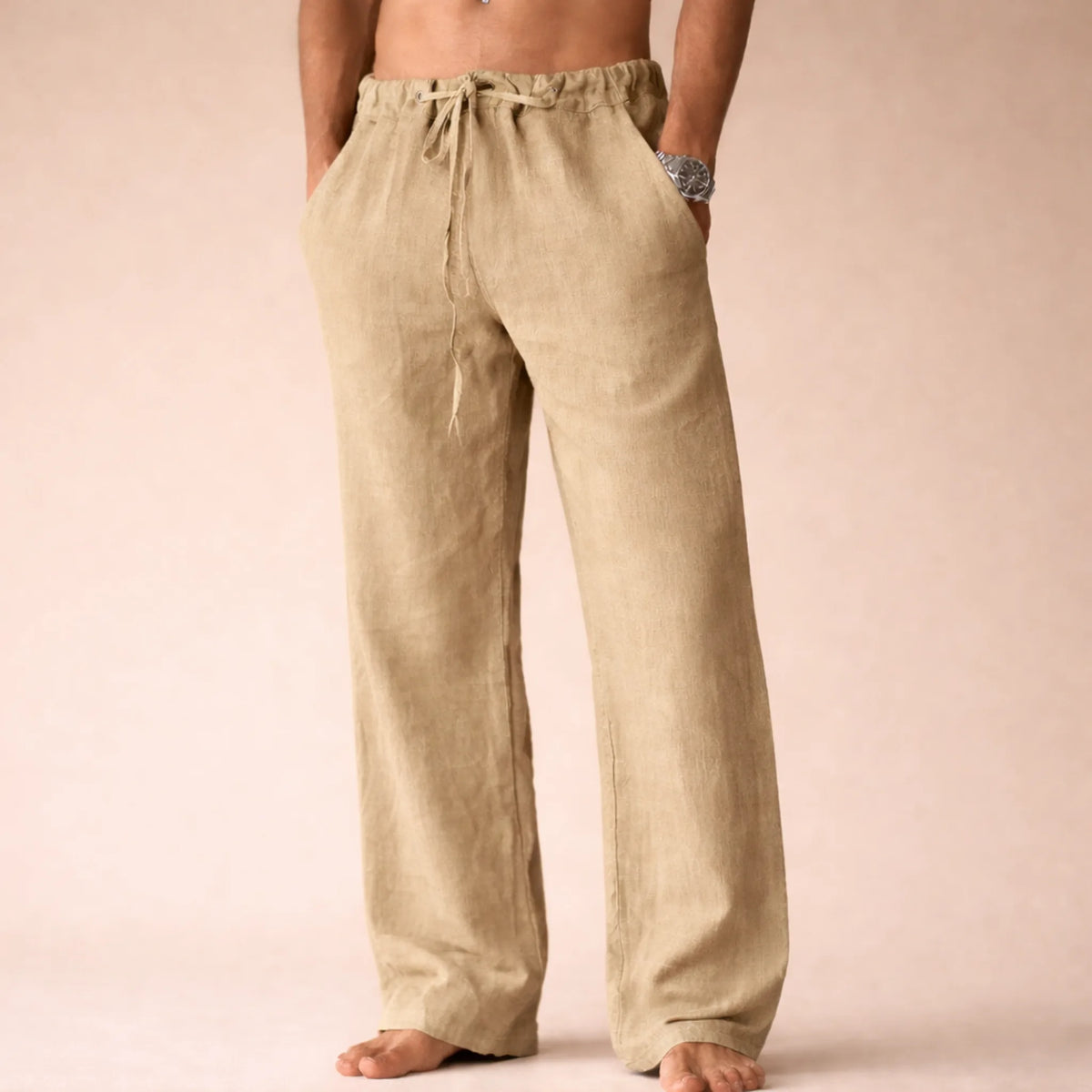 Khaki linen trousers with drawstring waist and hand in side pocket, showing the natural woven linen texture.