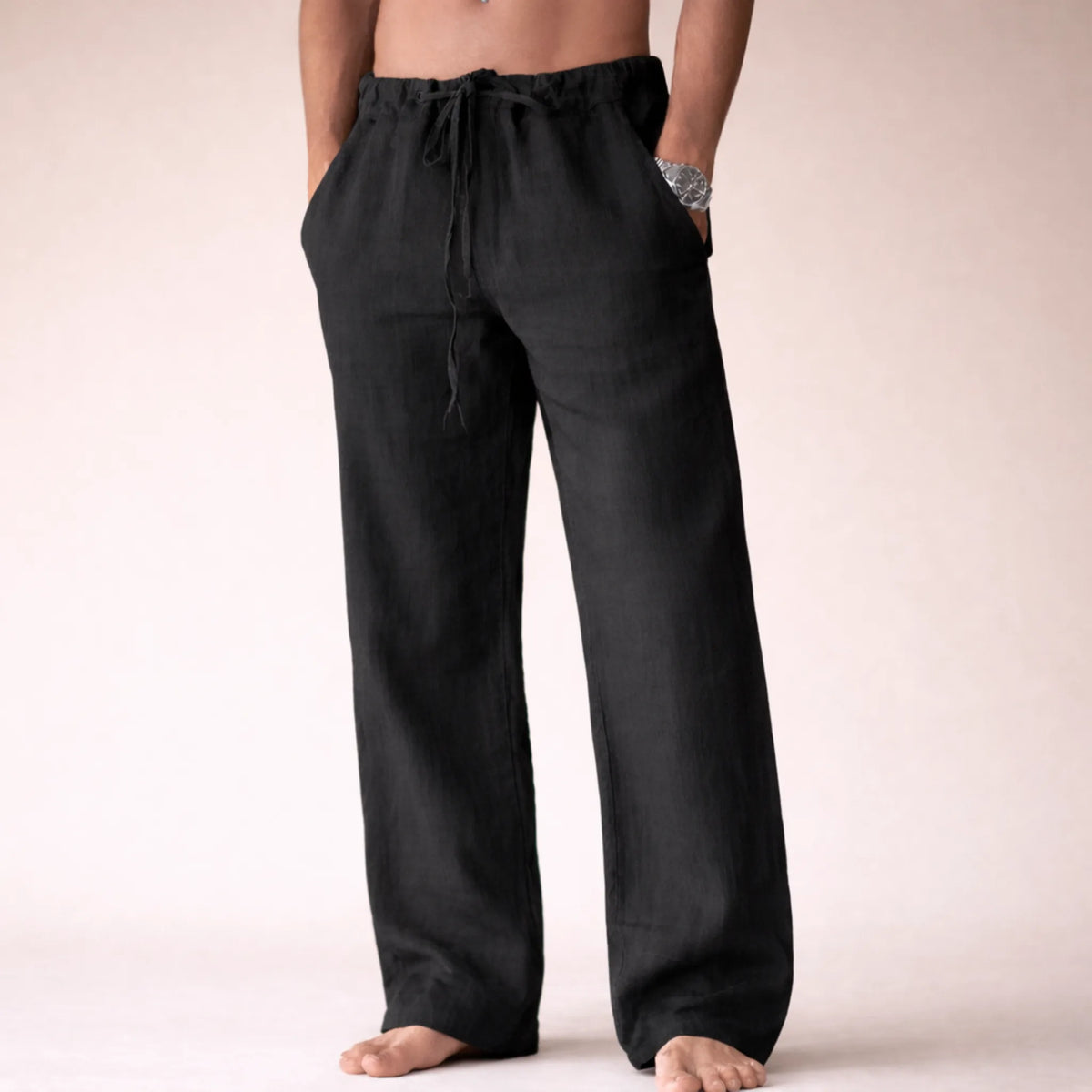Black linen drawstring pants shown from the front, highlighting the straight-leg silhouette and relaxed fit.