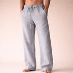 Light grey linen trousers with adjustable drawstring waistband, showing a soft relaxed drape from front view.