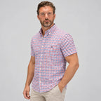 Side angle of the check shirt showing its relaxed fit and button-down collar styled with beige chinos