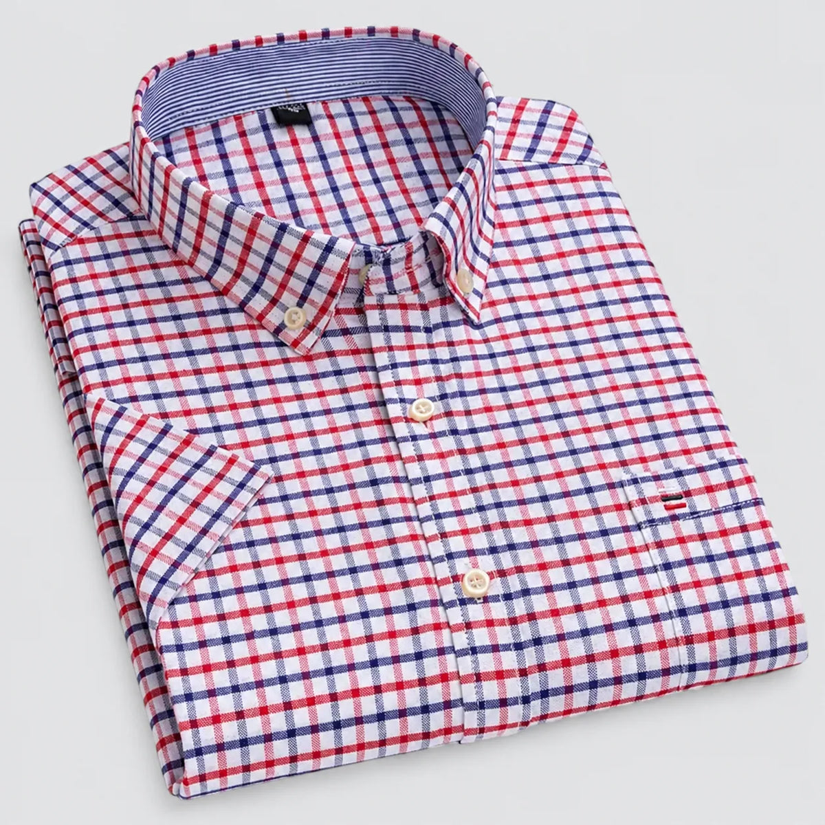 Folded shirt showing the check pattern, mother-of-pearl style buttons and contrast inner collar trim