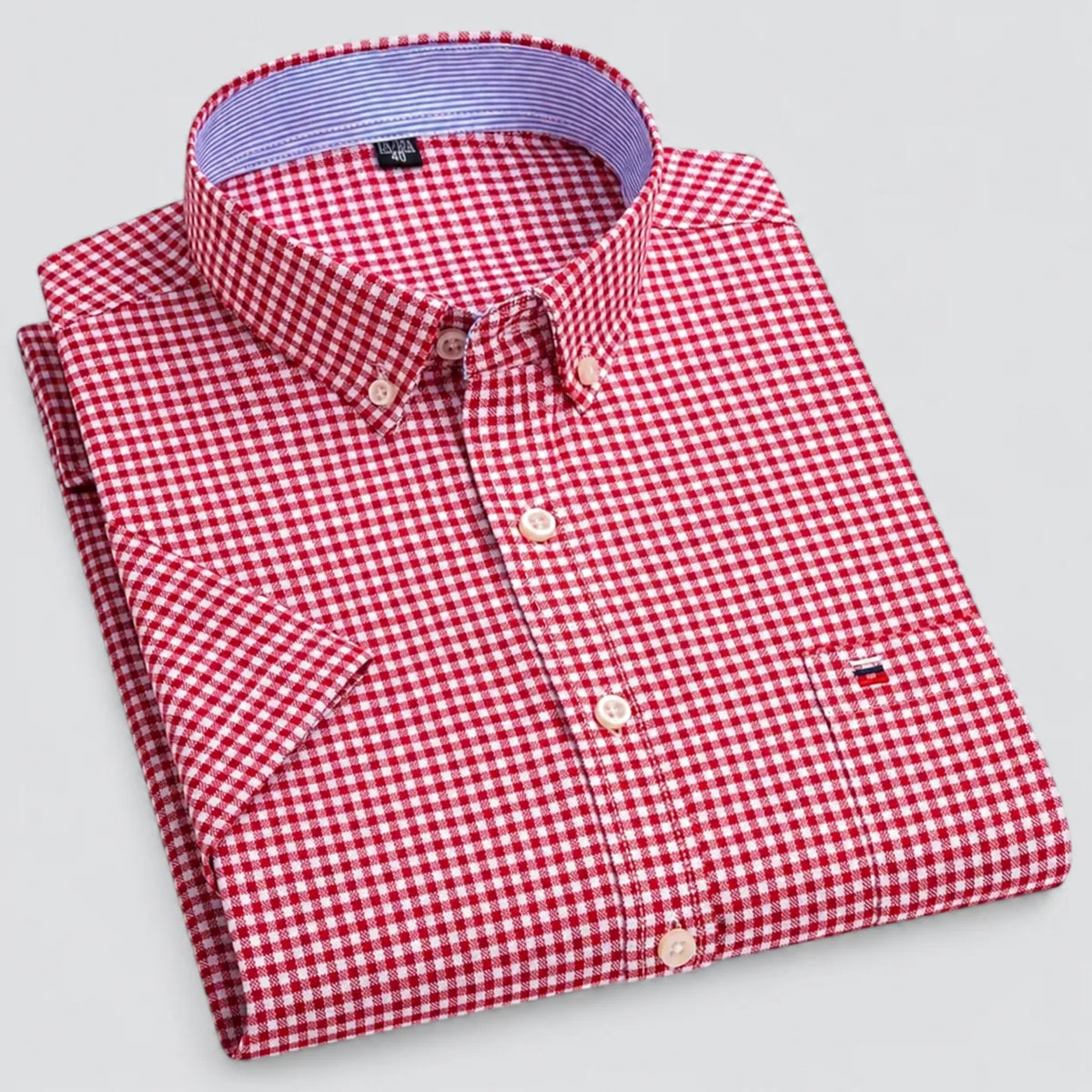 Folded red and white gingham shirt showing the striped inner collar lining and button placket