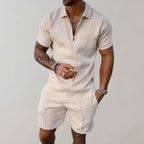 Beige textured polo and shorts set worn with a drink in hand, showing the geometric woven pattern