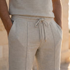 Close-up of the elasticated drawstring waistband and pintuck detail on grey knit shorts