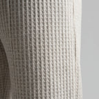 Macro shot showing the waffle knit texture and side seam of the grey fabric