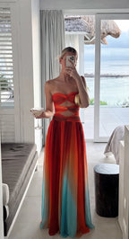 Mirror selfie showing the dress from the front with a beachfront view, highlighting the fluid chiffon fabric and gradient colourway.