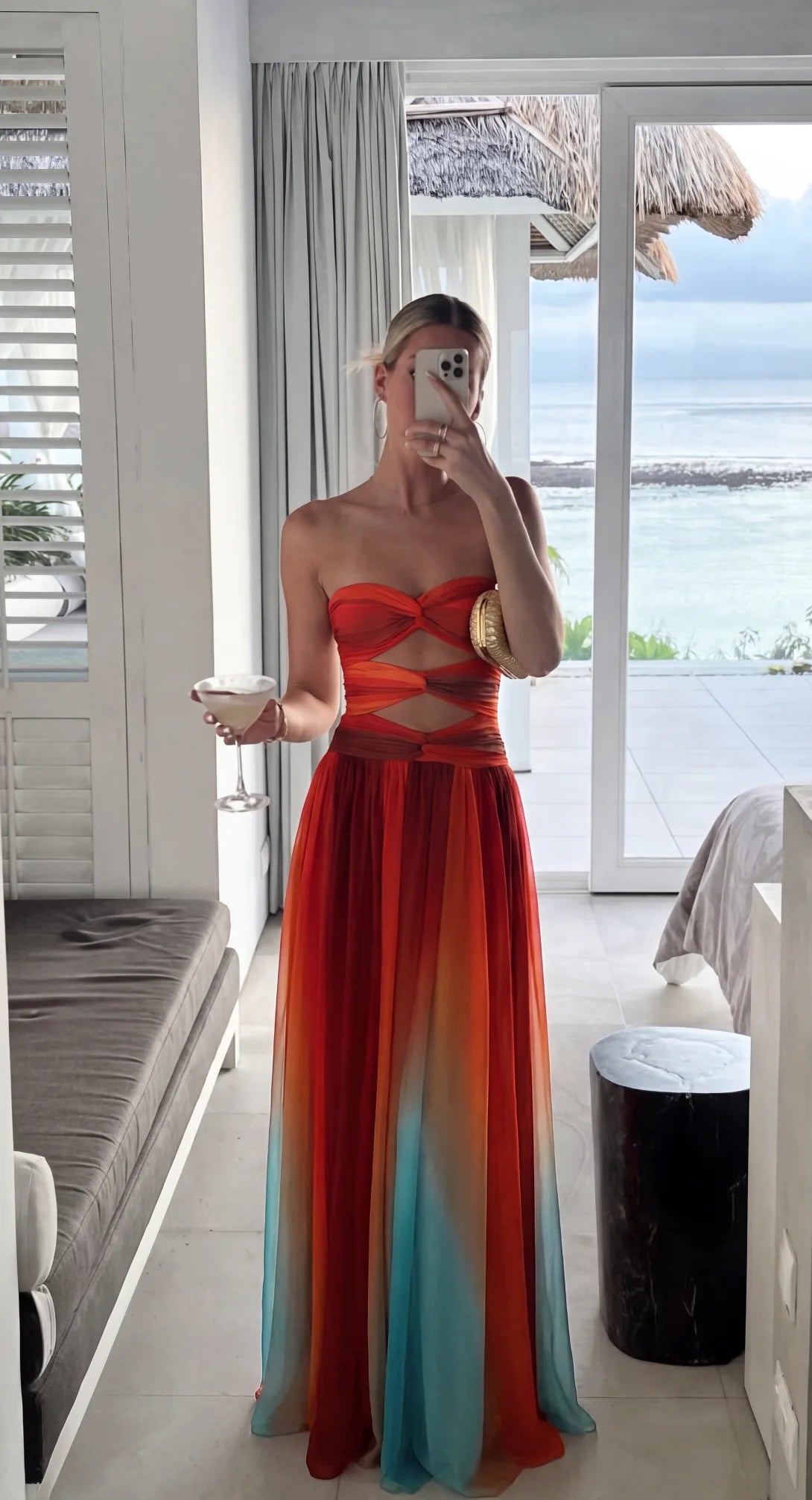Mirror selfie showing the dress from the front with a beachfront view, highlighting the fluid chiffon fabric and gradient colourway.