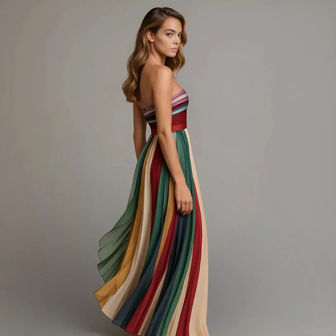 Side profile showing the fitted waistband and the pleated skirt flowing outward with soft vertical movement.
