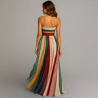 Back view showing the smocked waistband and the vertical pleated panels cascading into a floor-sweeping train.