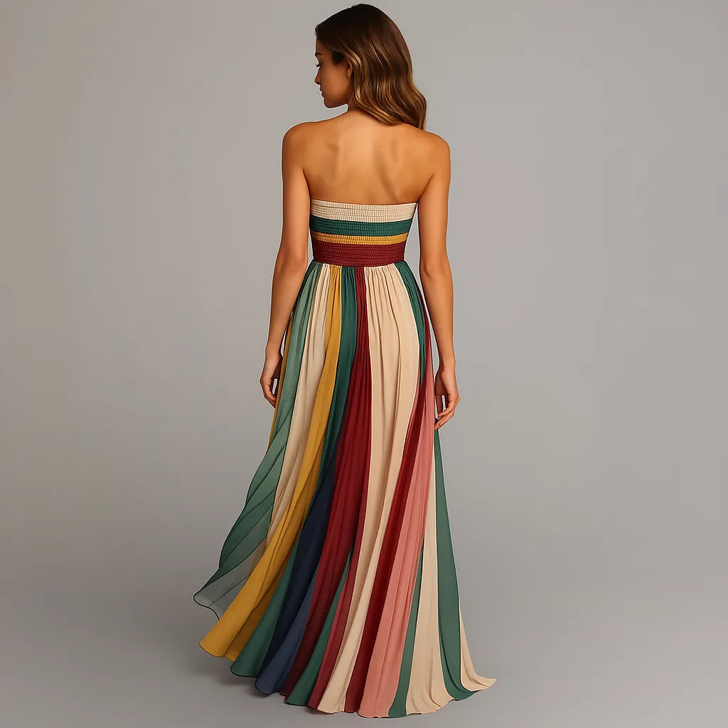 Back view showing the smocked waistband and the vertical pleated panels cascading into a floor-sweeping train.